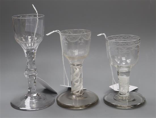 An 18th century cordial glass with bucket bowl and facet stem and two firing glasses, tallest 14cm (3)